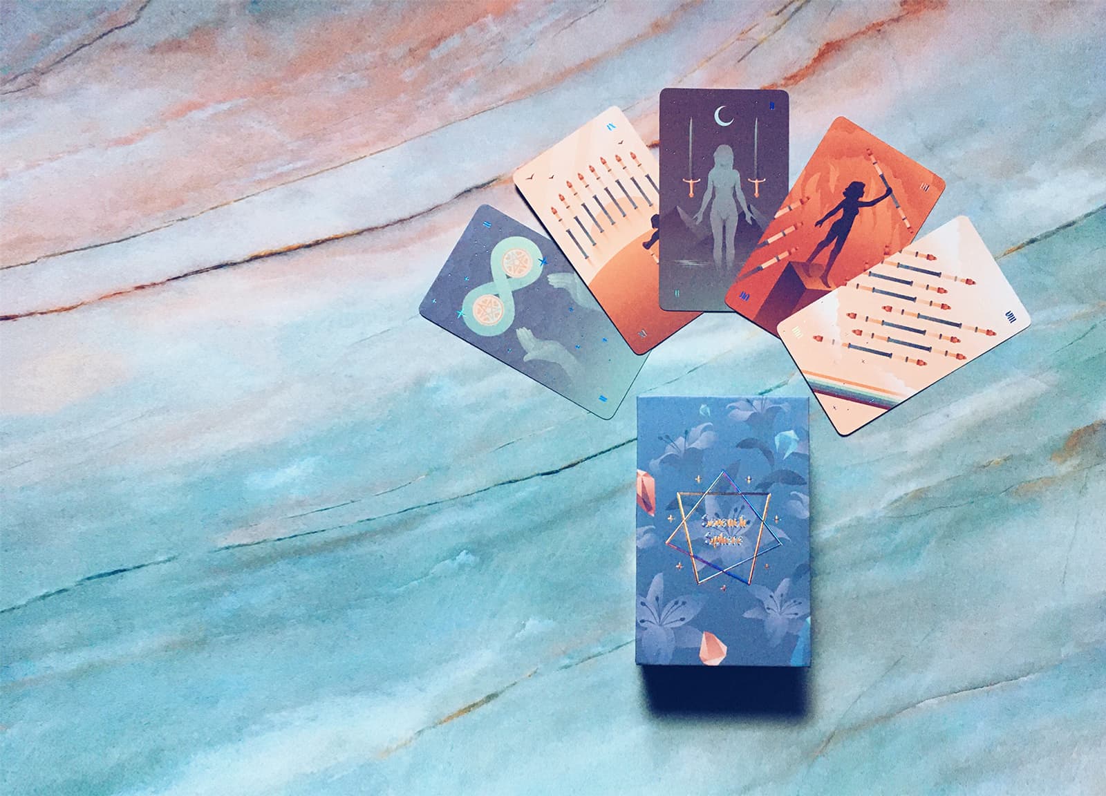 A Rider Waite Smith companion to the Seventh Sphere Marseille. Full bleed modern and calming illustrations, alongside blue holographic foil details and edges.