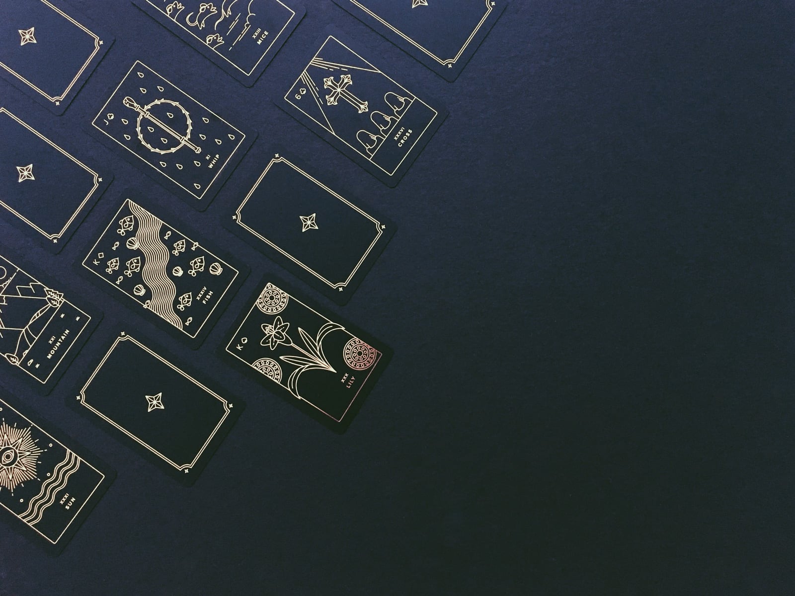 A minimalist and modern lenormand card deck printed with gold foil on sleek, matte, recycled plastic.